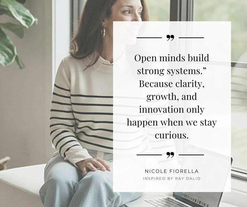 AI-generated brand photo by Nicole Fiorella Creative using her headshot — woman with laptop near window, featuring a motivational quote about curiosity and building strong creative systems