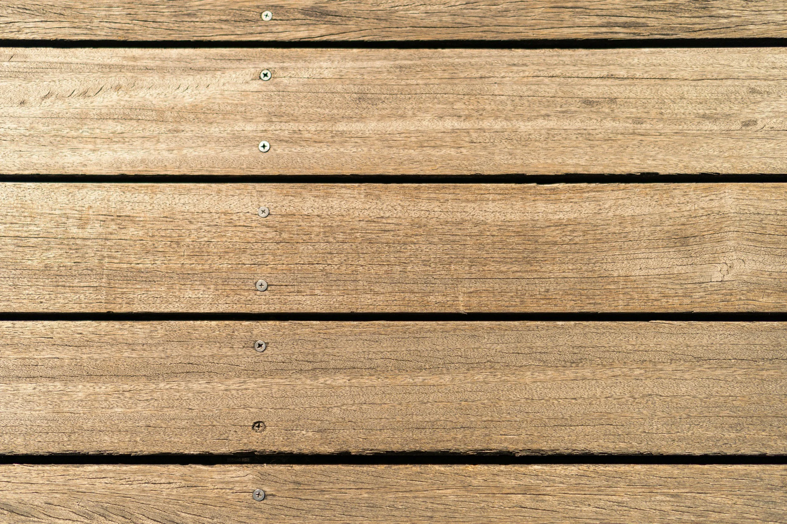 Close-up photo of horizontal wooden planks with screws.