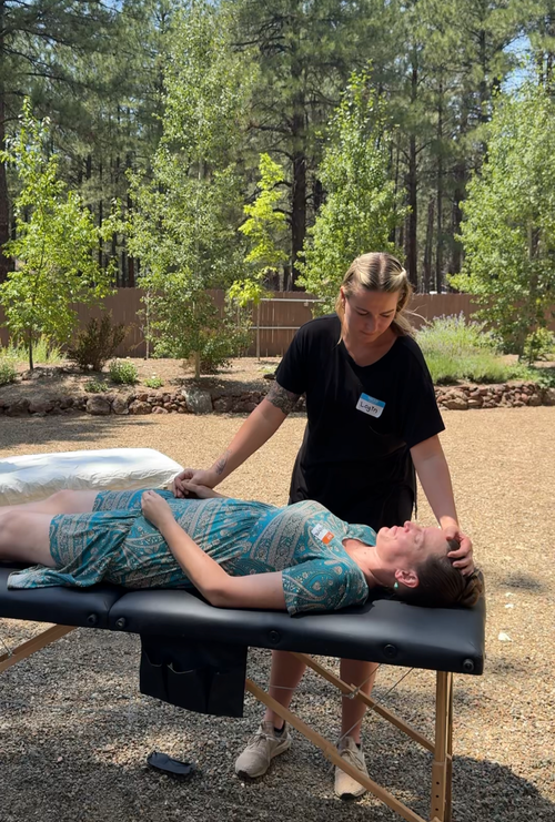 Practitioner providing therapeutic bodywork in a treatment room