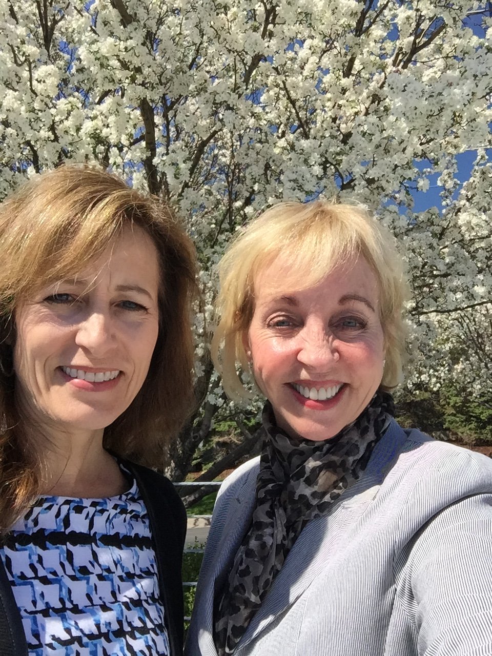 Janell and Barbara in front of a beautiful white floral tree