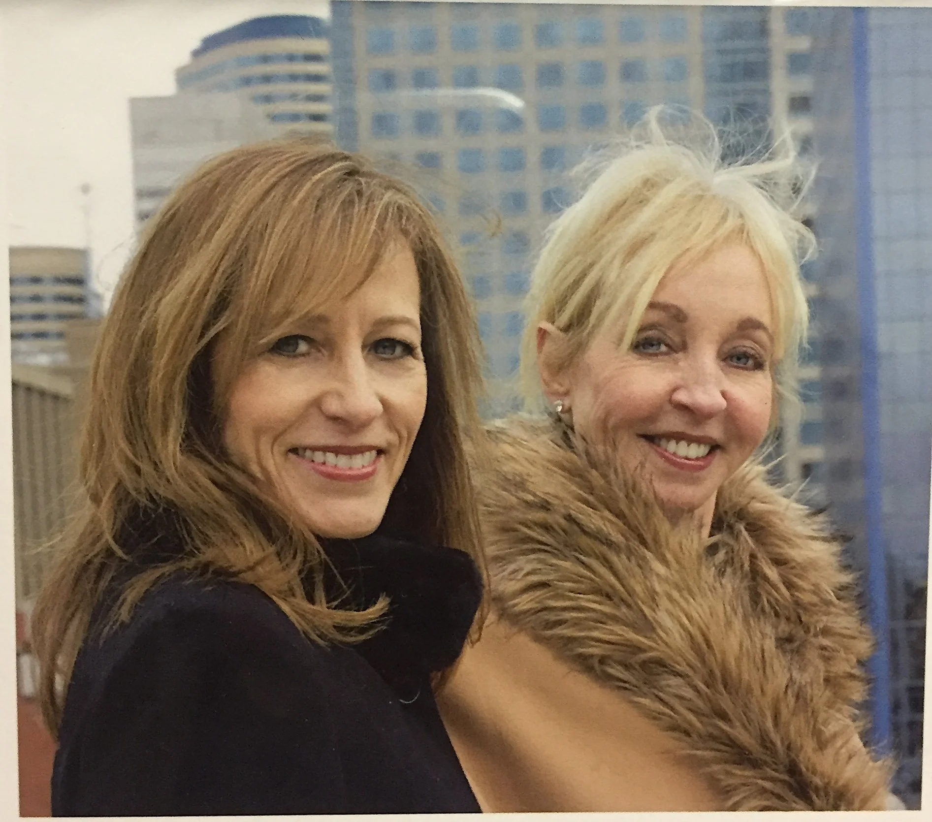 Janell and Barbara with buildings behind them