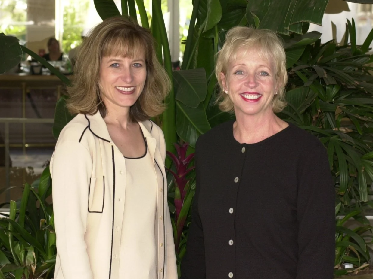 Janell and Barbara in front of palms