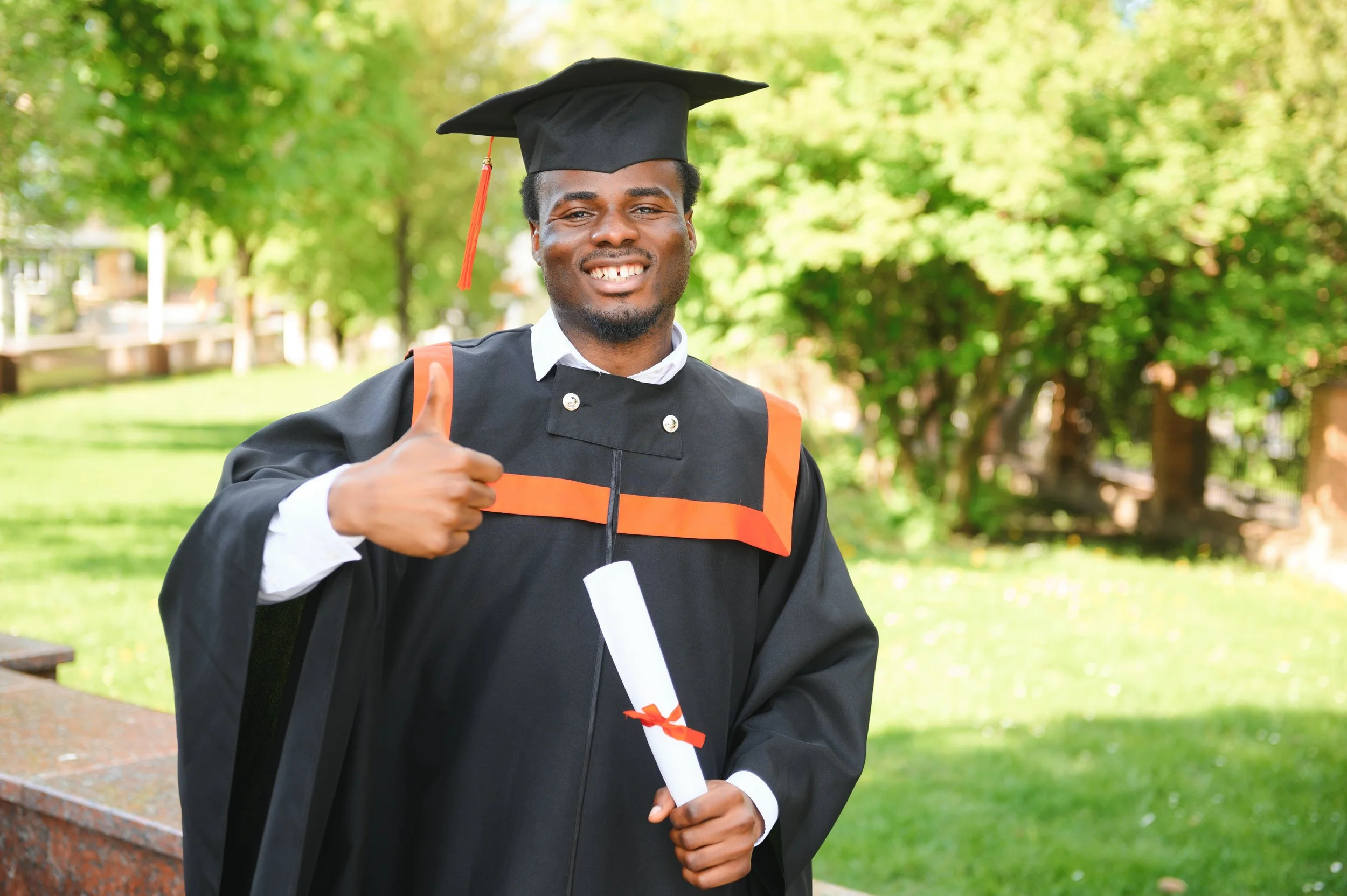 vecteezy_happy-graduate-happy-african-man-in-graduation-gowns_46381243.jpg
