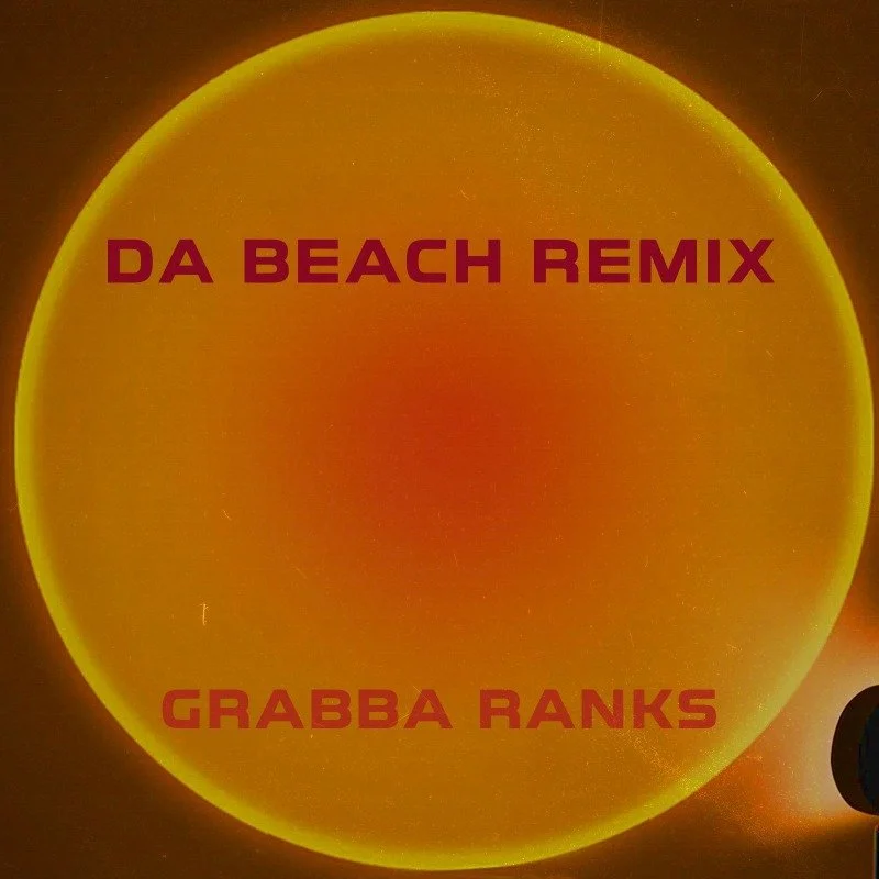 A circular, orange and yellow colored graphic with text in the center that reads "DA BEACH REMIX" at the top and "GRABBA RANKS" at the bottom.
