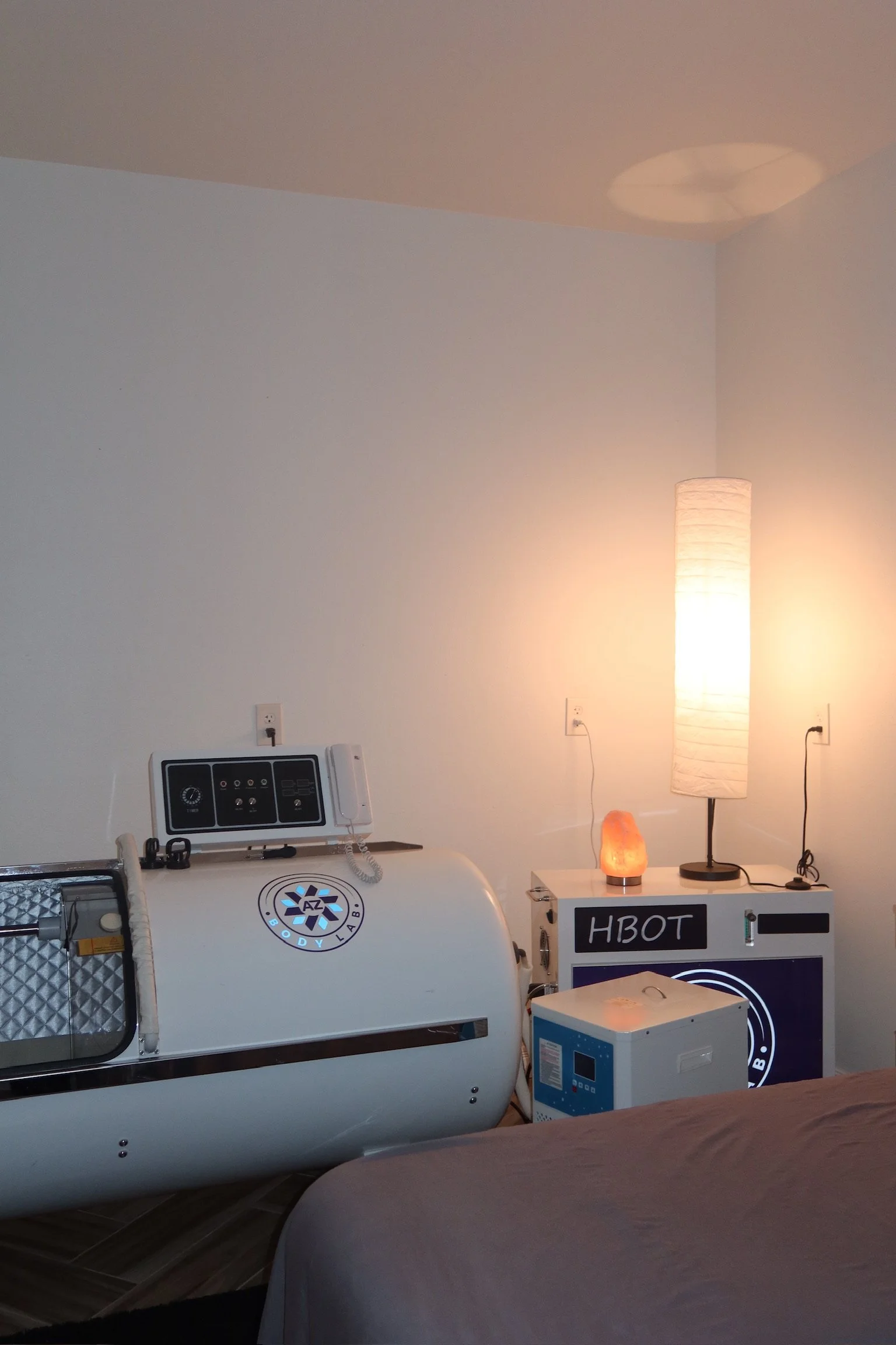 Medical or therapy room at a Surprise AZ Spa with a white pod labeled 'AZ BODY LAB', soft lighting, and relaxing ambiance