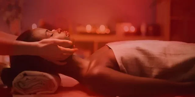 Close-up of massage with red light therapy and grounding sheets on massage table
