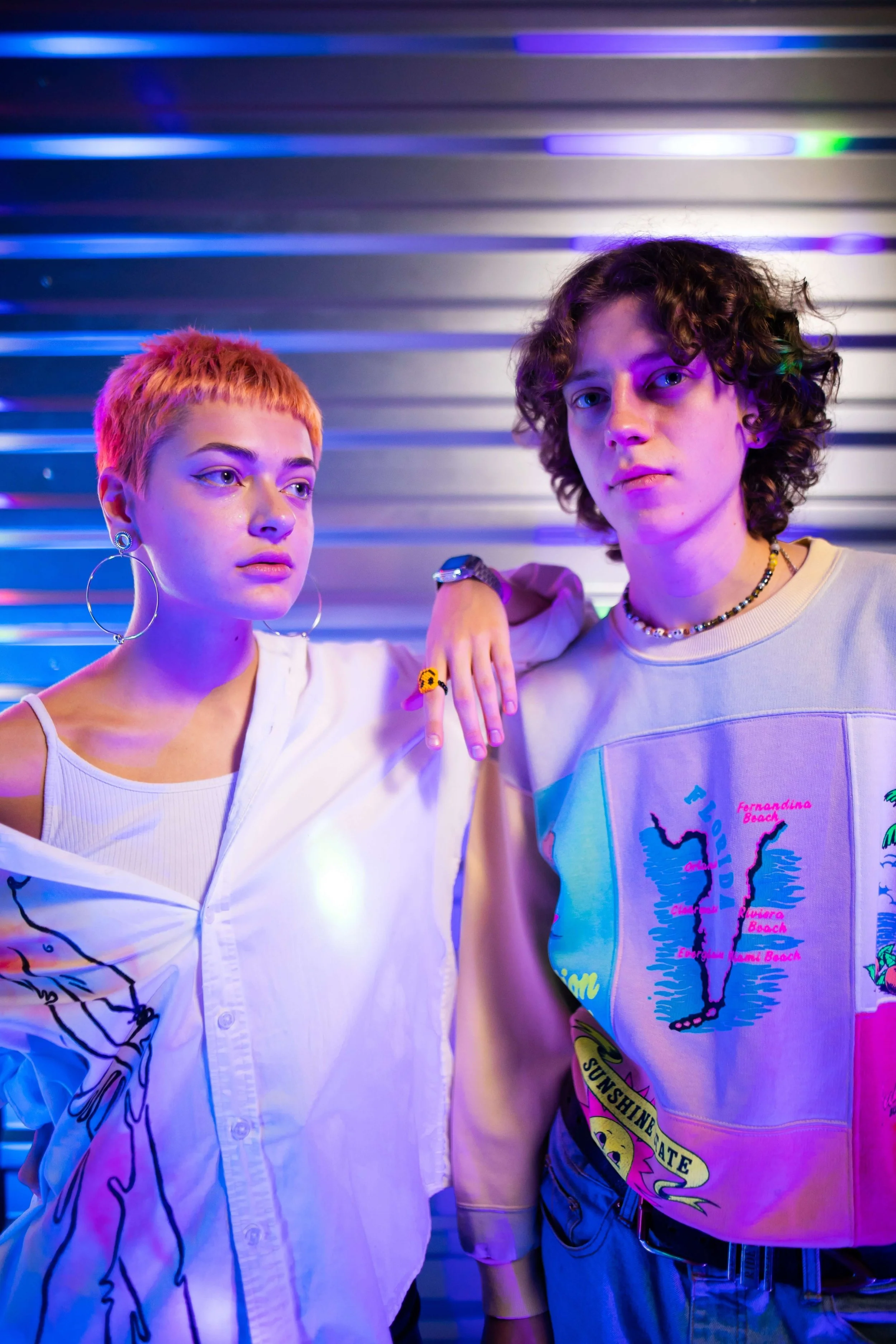 Two hip young adults stand together supporting each other in their journey of self-discovery. Get more support and guidance in Therapy for Young Adults in NYC.