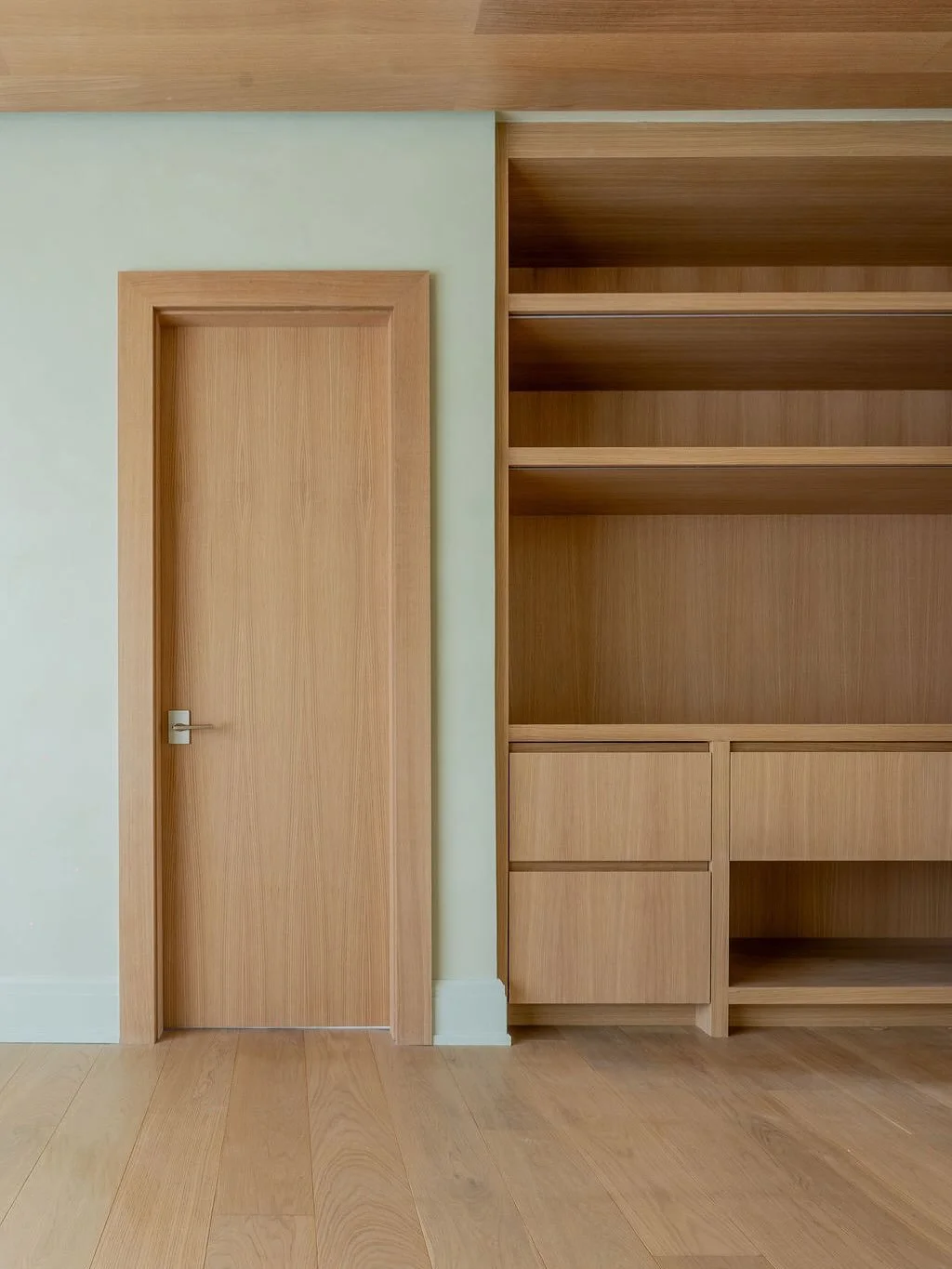 A recently completed interior remodel in collaboration with @monicafrieddesign featuring stunning rift sawn white oak millwork and Venetian plaster throughout.  Our scope of work included a revamped media room, yoga studio, primary suite, entry foyer