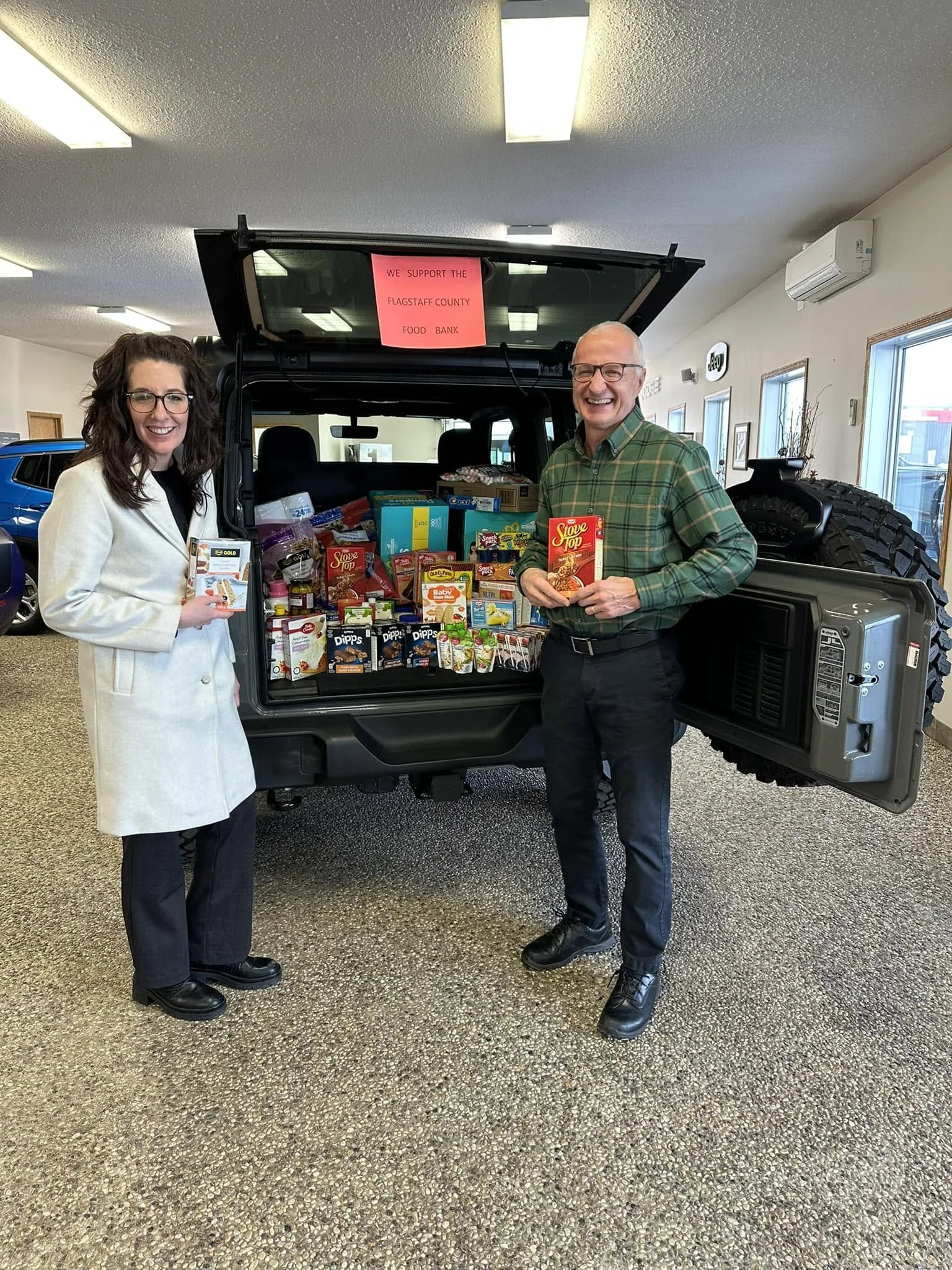 Campbell McLennan Stuffs a Car for the Flagstaff Food Bank