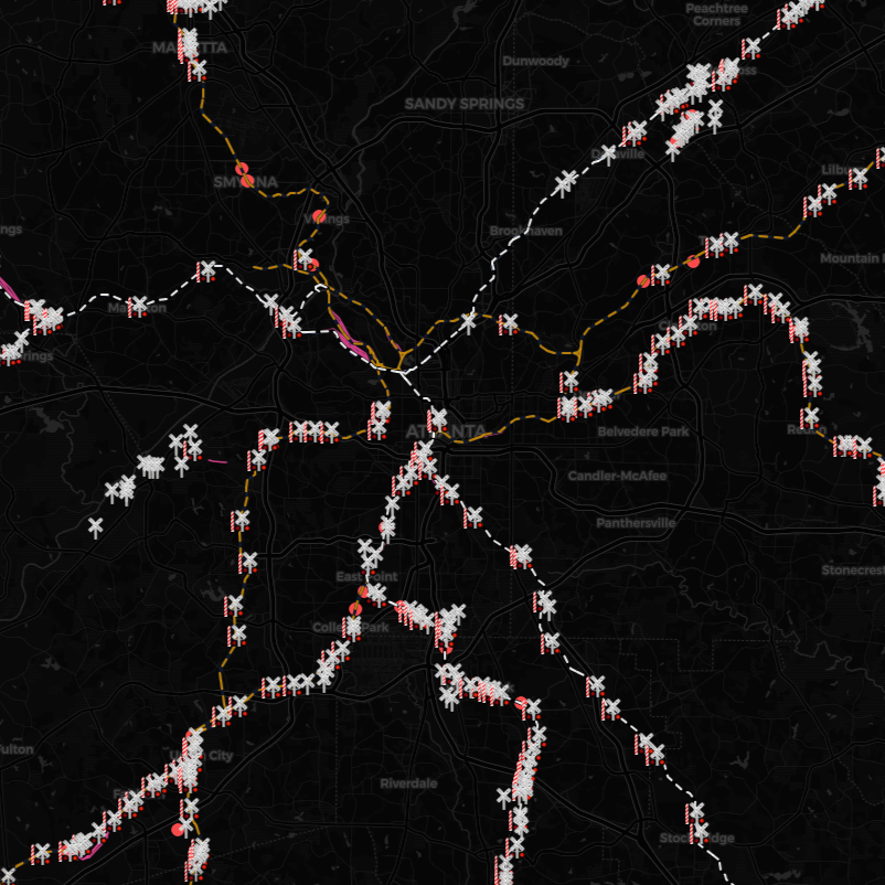 A map showing train or transit routes with congestion or incidents marked by icons, overlaid on a dark background of a city.