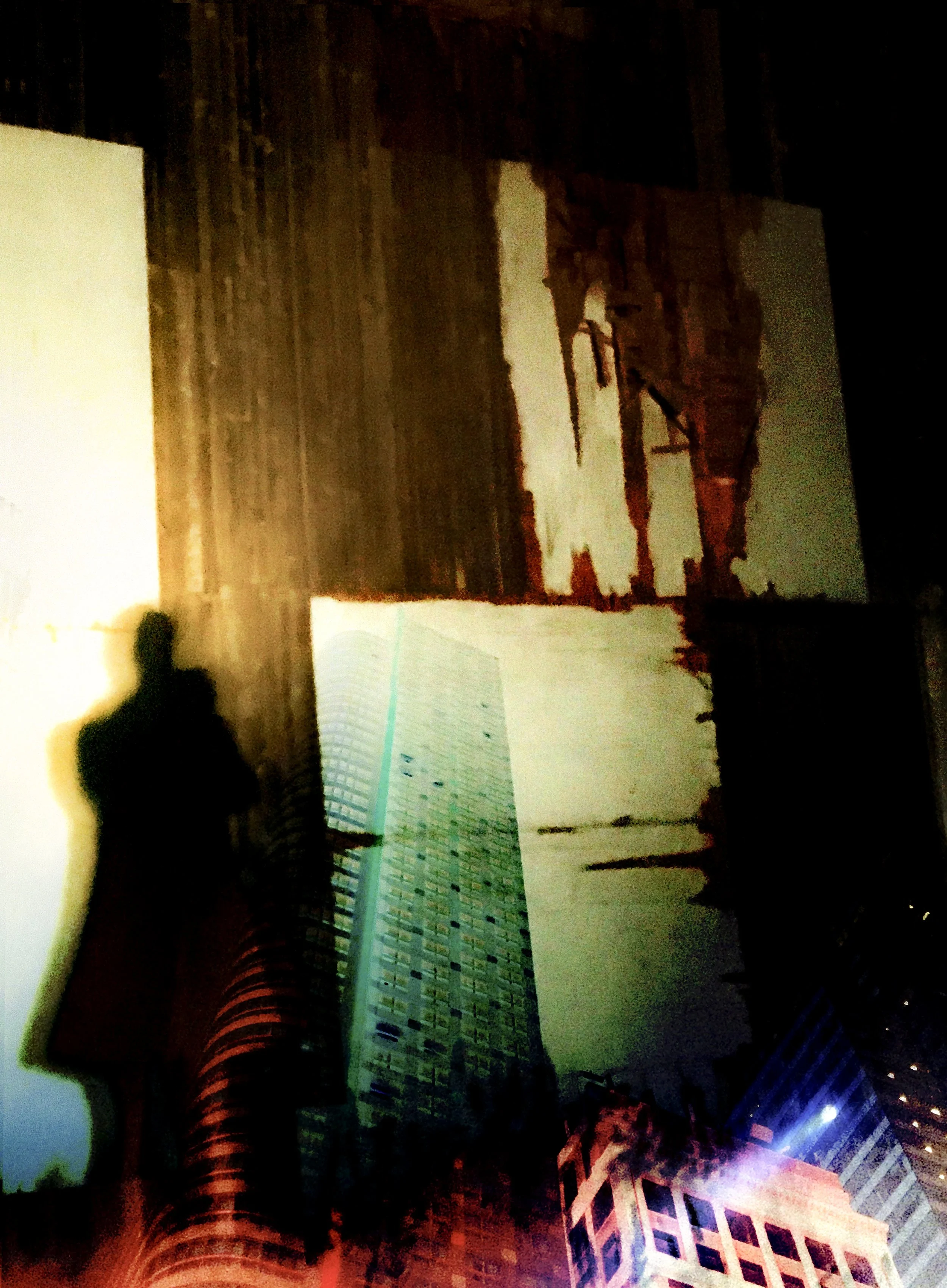 Nighttime cityscape with tall buildings, some illuminated, with a silhouette of a person taking a photo reflected on a glass surface.