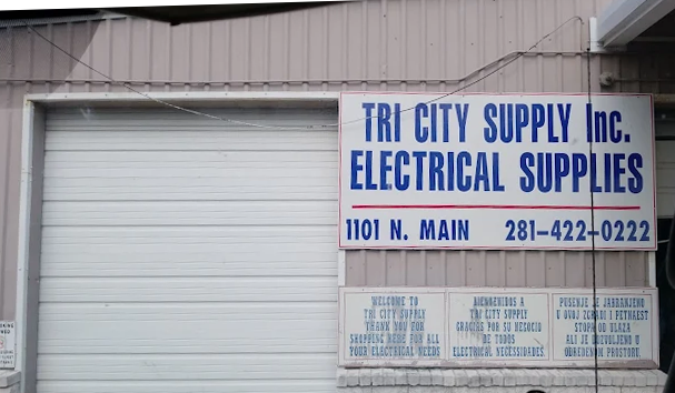 Sign for Tri City Supply Inc. Electrical Supplies with address 1101 N. Main and phone number 281-422-0222 on a warehouse or storefront building.