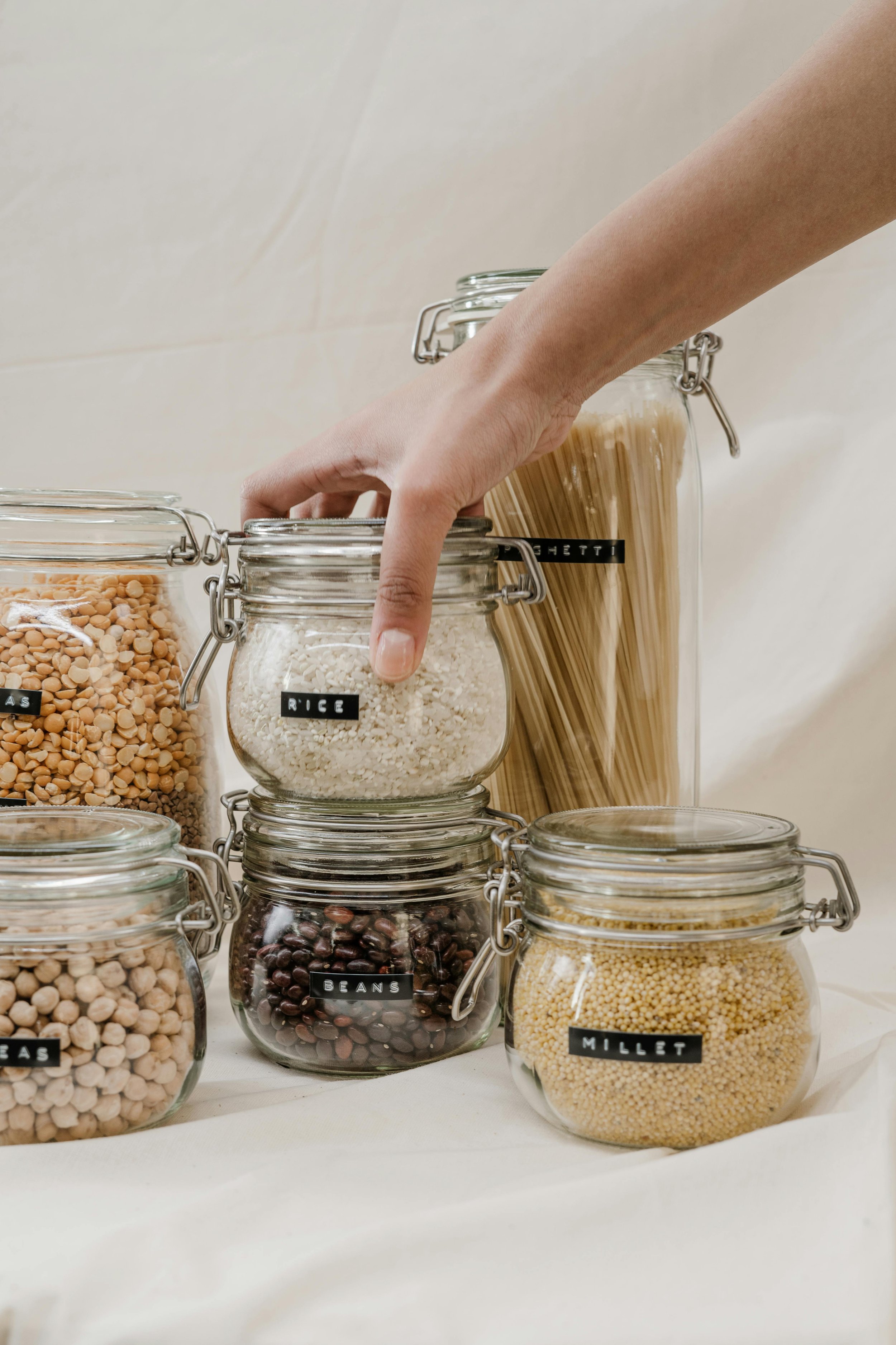 Hand reaching for a jar. Downsizing and decluttering to prepare for a senior moving to a smaller home or care facility.