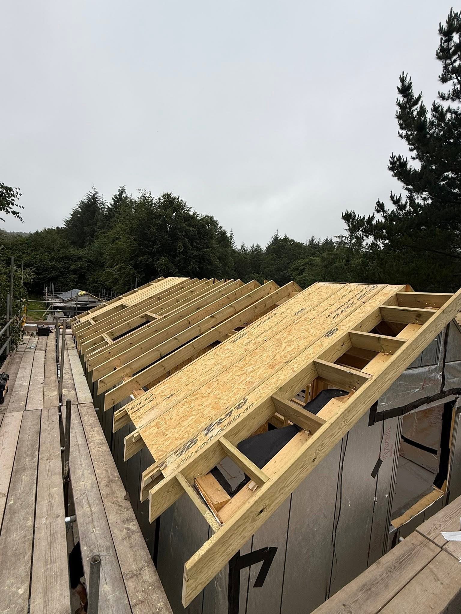 Roof trusses and sheathing fitted from the scaffold