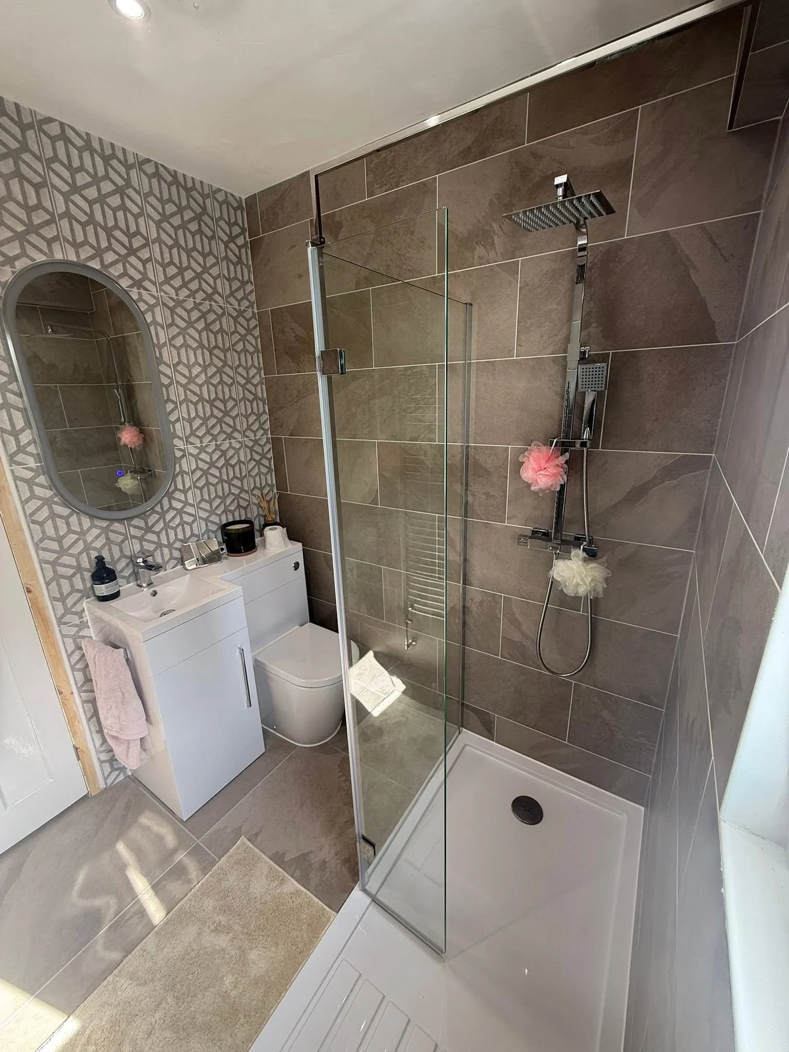Renovated bathroom with walk-in shower enclosure and new vanity unit