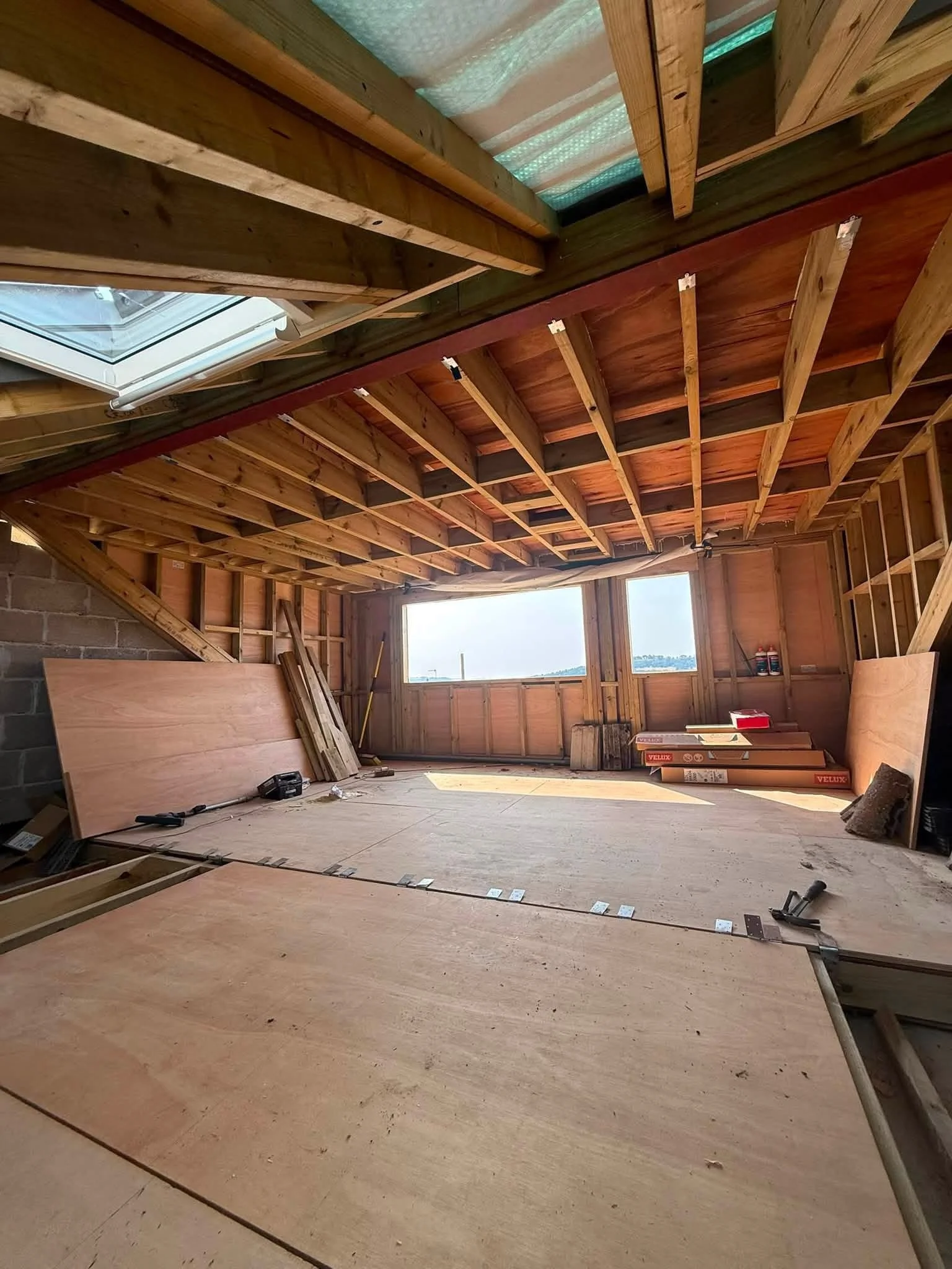 Exposed timber roof structure inside a loft conversion