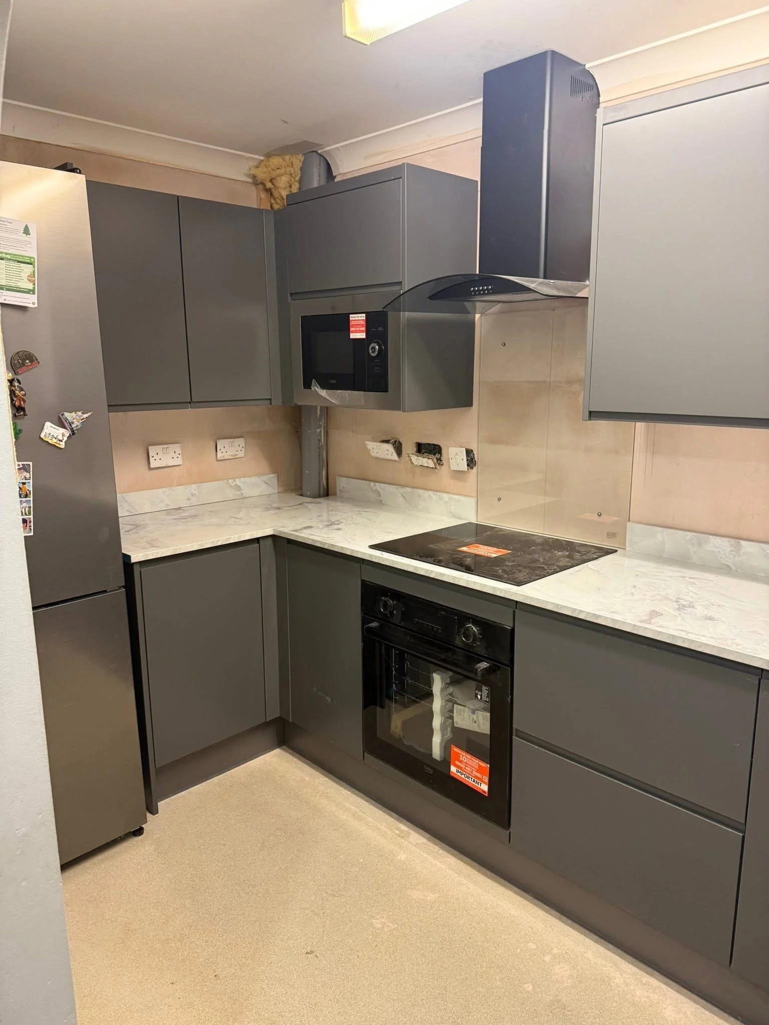 Grey handleless kitchen fitted during a home renovation