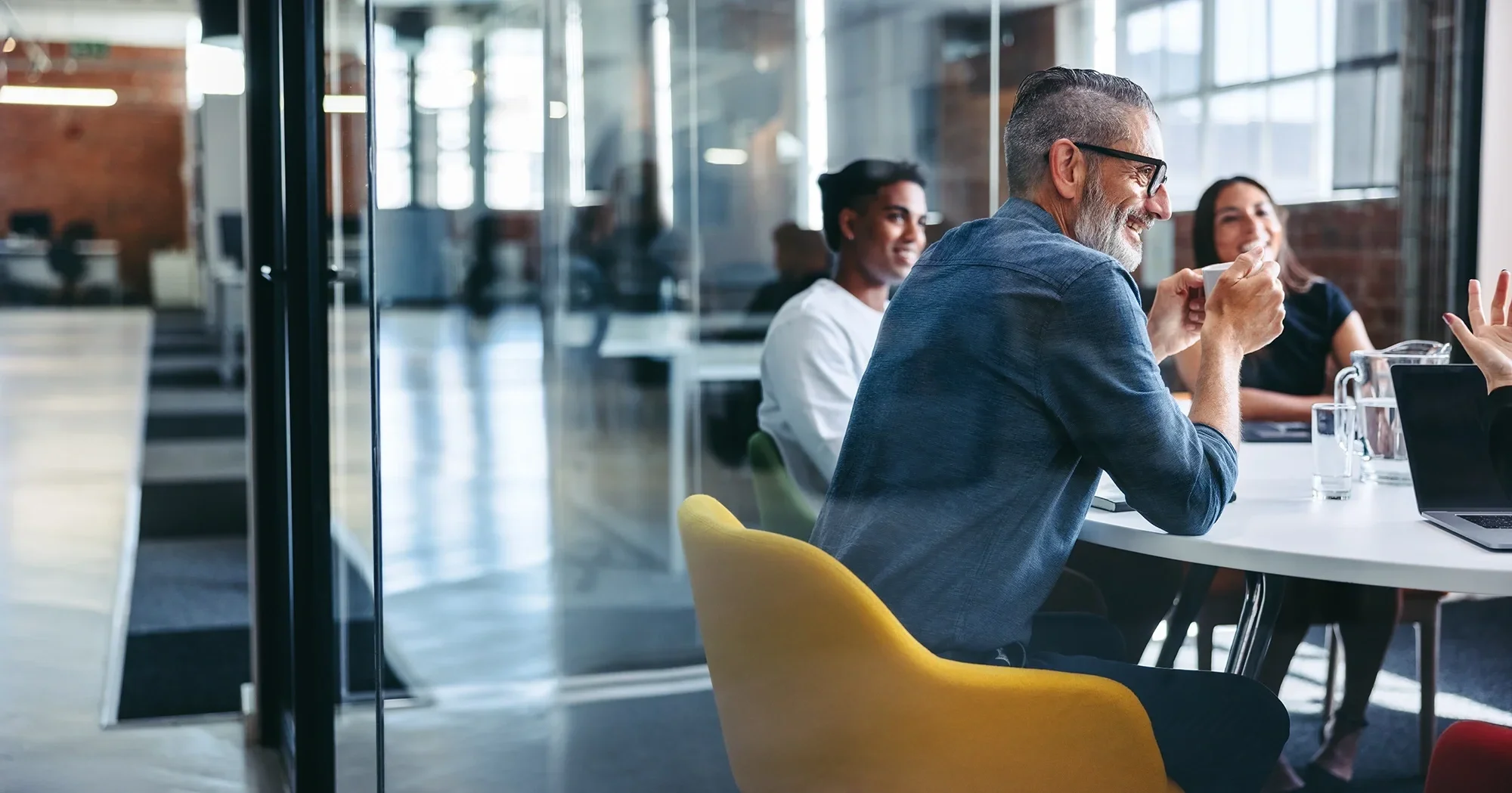 professionals laughing in a meeting