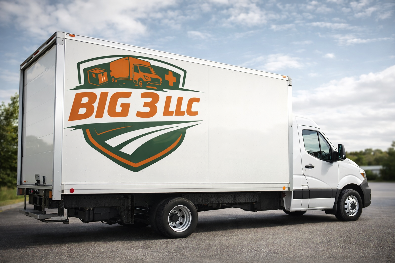White delivery truck with a logo that reads "BIG 3 LLC" and features a graphic of a moving truck, a medical cross, and a road with a shield shape background, parked on a paved surface under a partly cloudy sky.