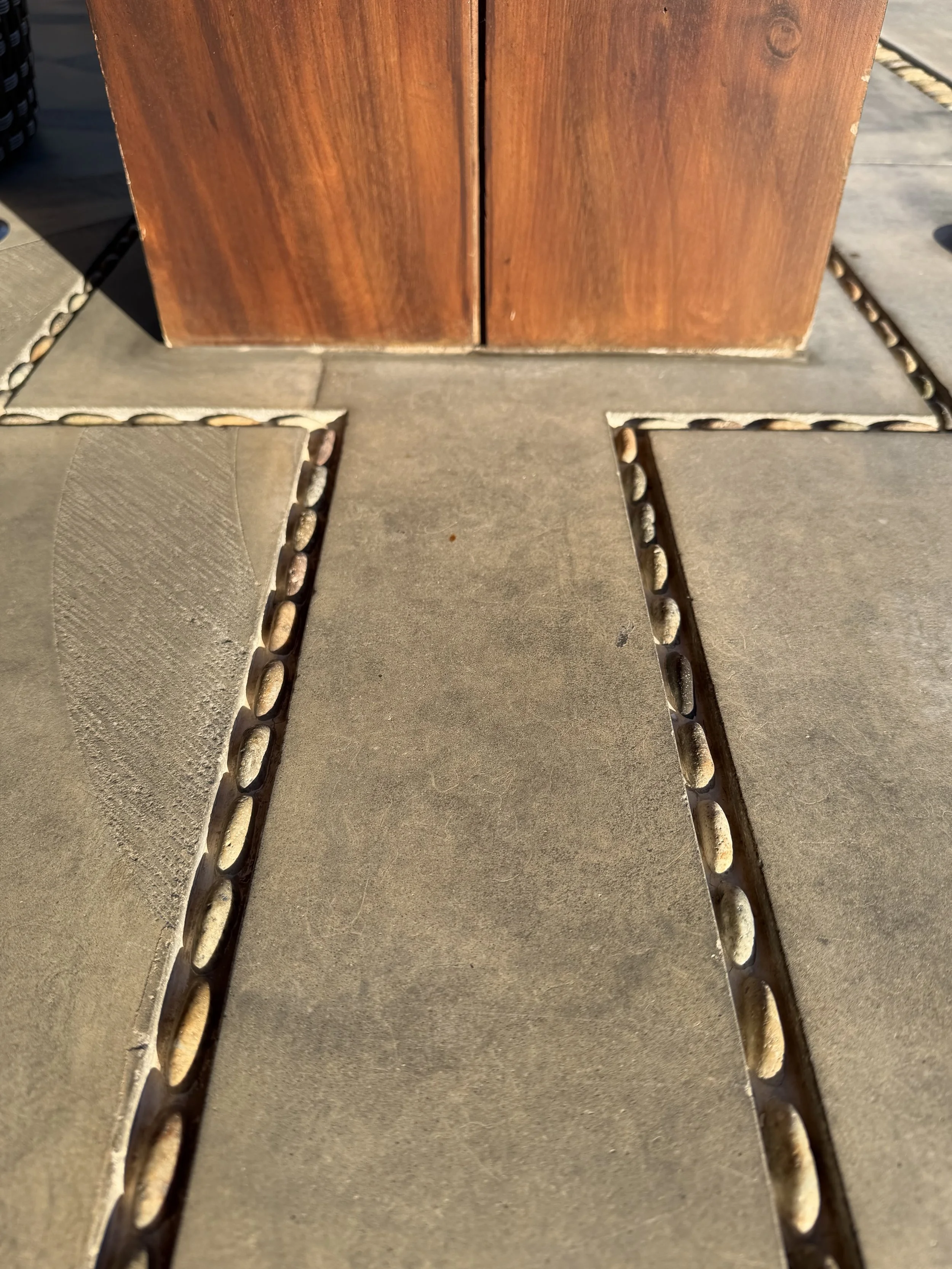 Simplicity, beautiful rock detail design on concrete floor and wood column.