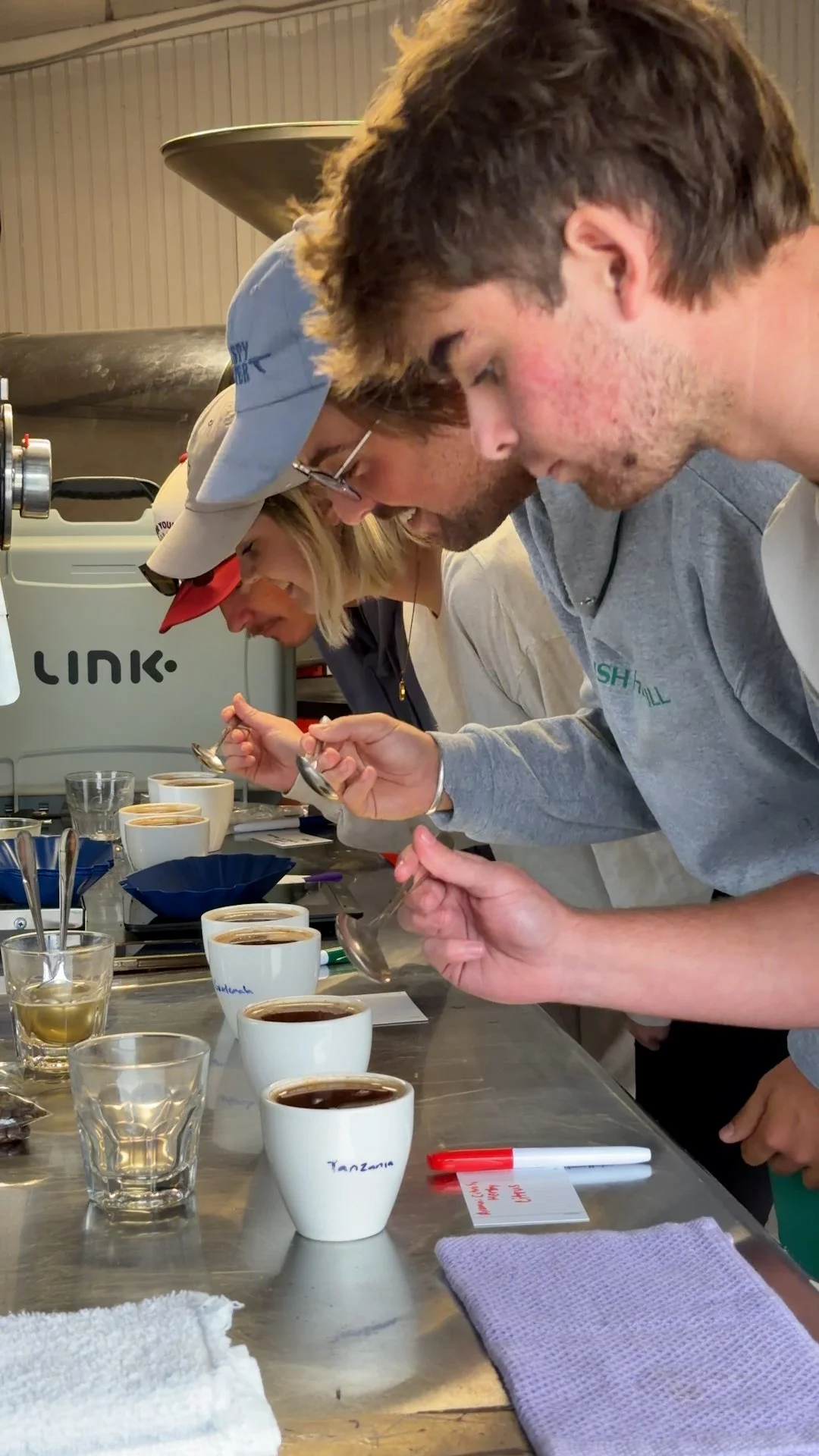 From above hands of unrecognizable woman rubbing aromatic spices into piece of raw meat over parchment paper
