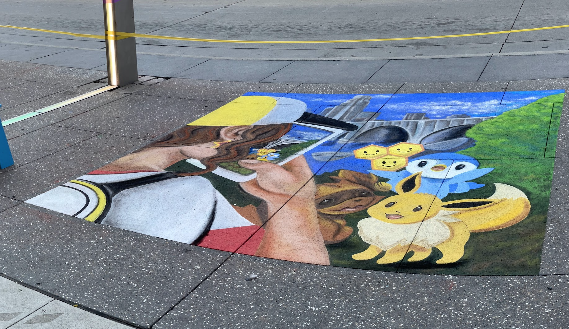Chalk art Temporary art installation of a Pokemon trainer and Pokemon gathering for a photo opp
