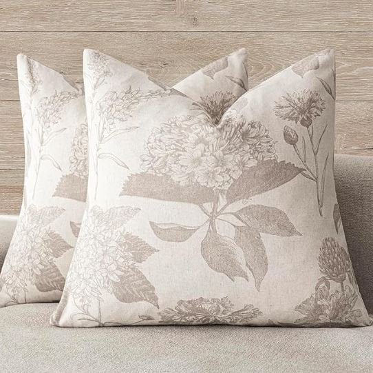 Living room design Inspiration featuring a stylish shoppable  decorative pillows with floral patterns on a light-colored sofa.