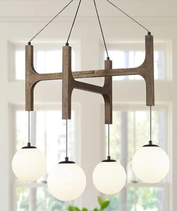 Interior design Inspiration featuring a stylish shoppable chandelier with a wooden frame and four globe-shaped white light fixtures hanging from cords