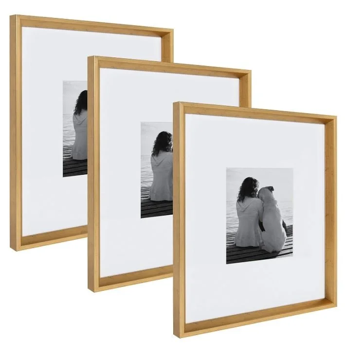 Interior design Inspiration featuring a stylish shoppable three wooden picture frames with black and white photos of two women sitting by the water, facing away from the camera.