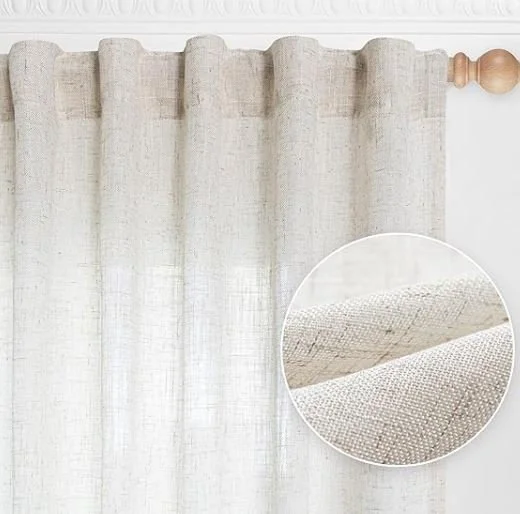Interior design inspiration featuring a stylish and shoppable light-colored textured curtain hanging on a window with a wooden curtain rod.