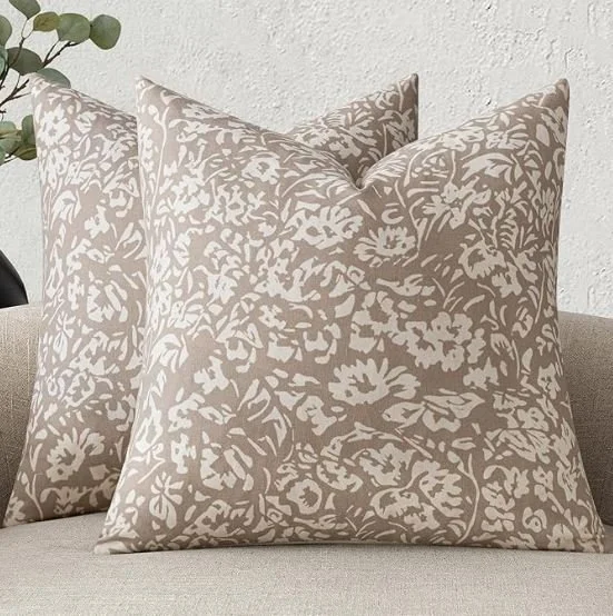 Living room design Inspiration featuring a stylish shoppable  decorative throw pillows with beige floral pattern on a light-colored sofa.