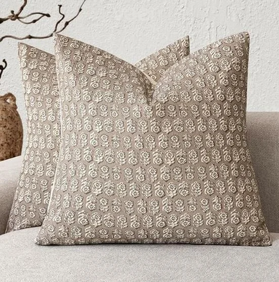 Living room design Inspiration featuring a stylish shoppable  decorative throw pillows with a beige and white floral pattern on a light-colored sofa.