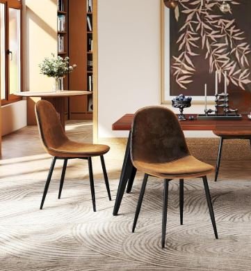 Interior design Inspiration featuring a stylish shoppable brown dining chairs with black legs in a bright room with wooden floors and a decorative wall hanging