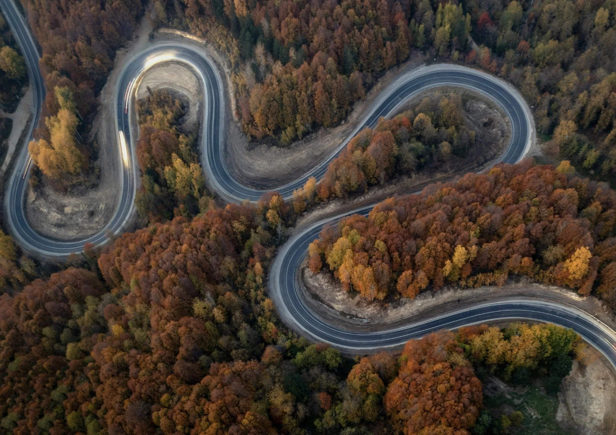 A long, winding road through hills, symbolizing the life changes and journey of living with a chronic illness; therapy in Houston and throughout Texas.