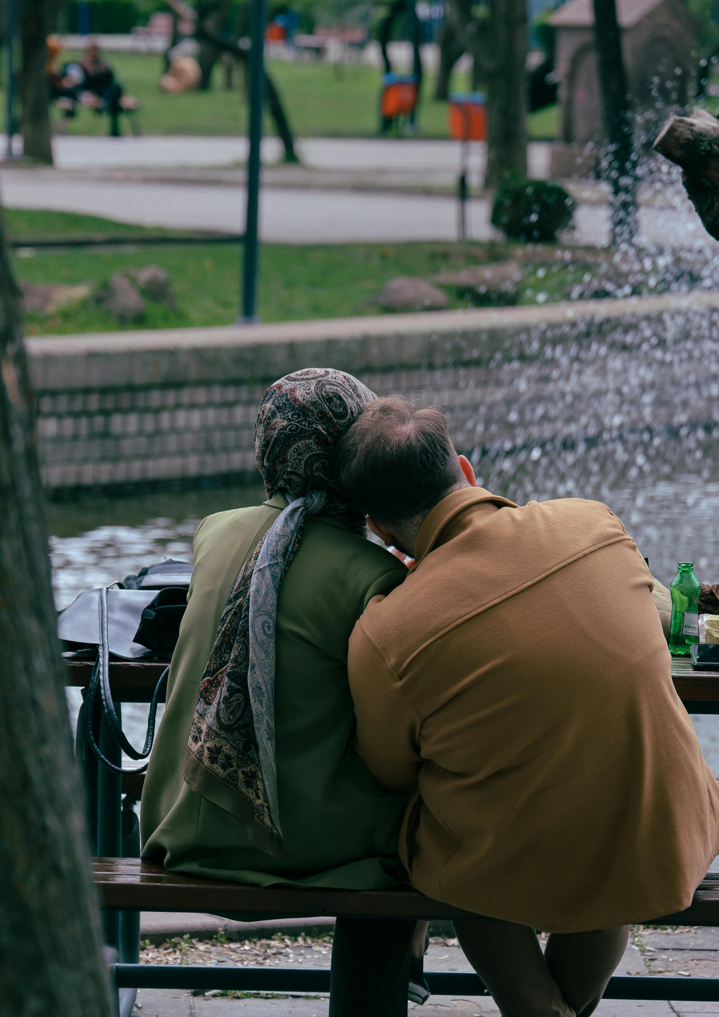 One person gently leaning their head on another's shoulder, illustrating the need for support when navigating deep loss.