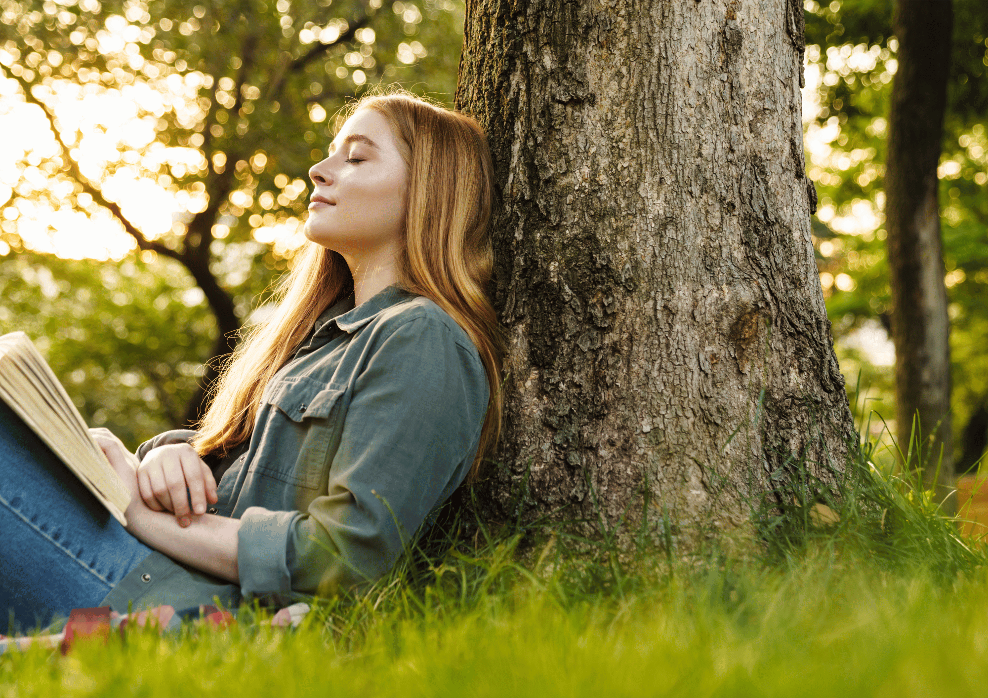 Person sitting against a tree in a forest, representing finding new perspective through chronic illness therapy for adults in Houston.