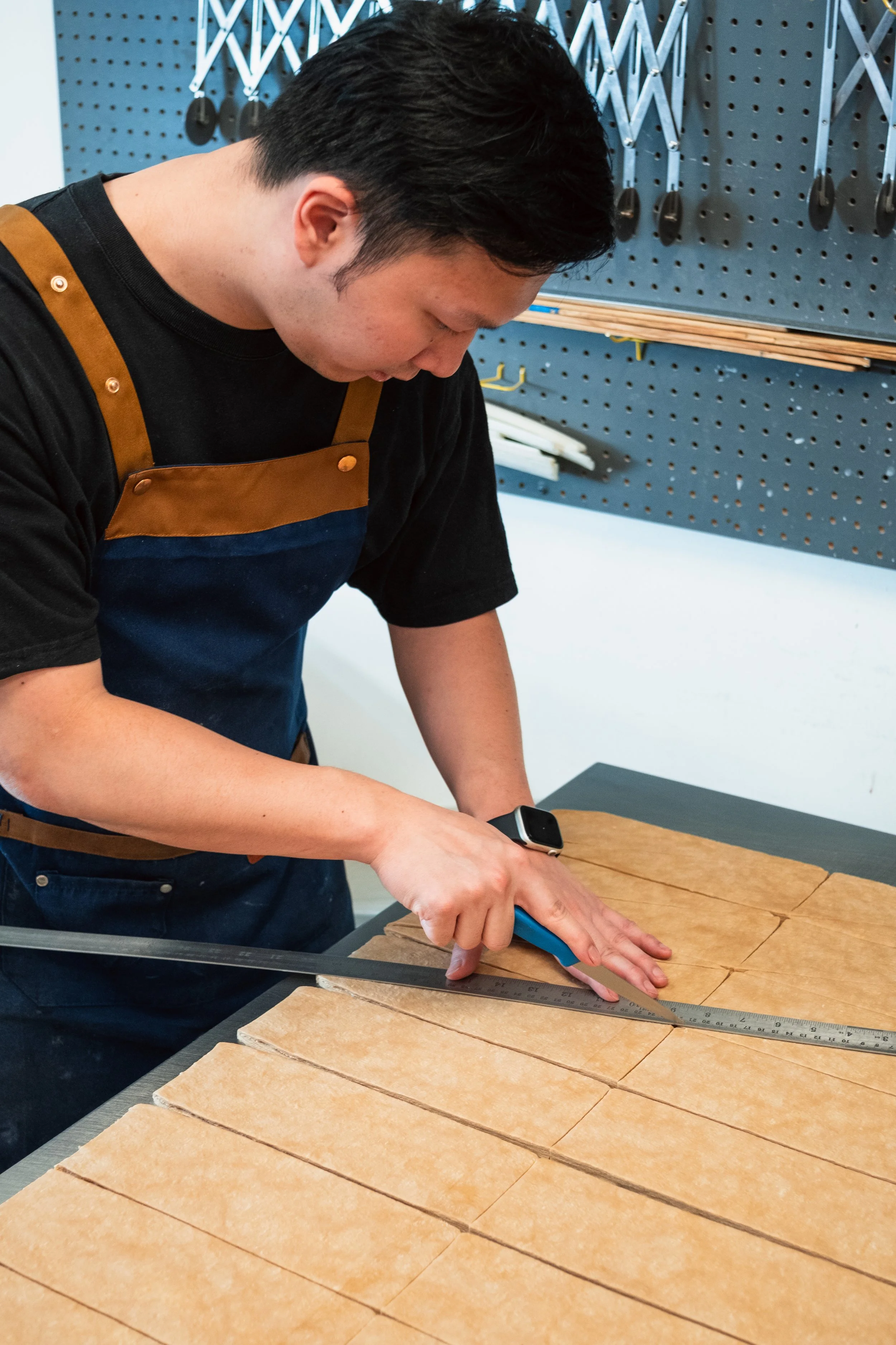 Cutting Dough Triangles at Butterblock & Co in Calgary, AB. Photograph by Zachery Knudson. All rights reserved.