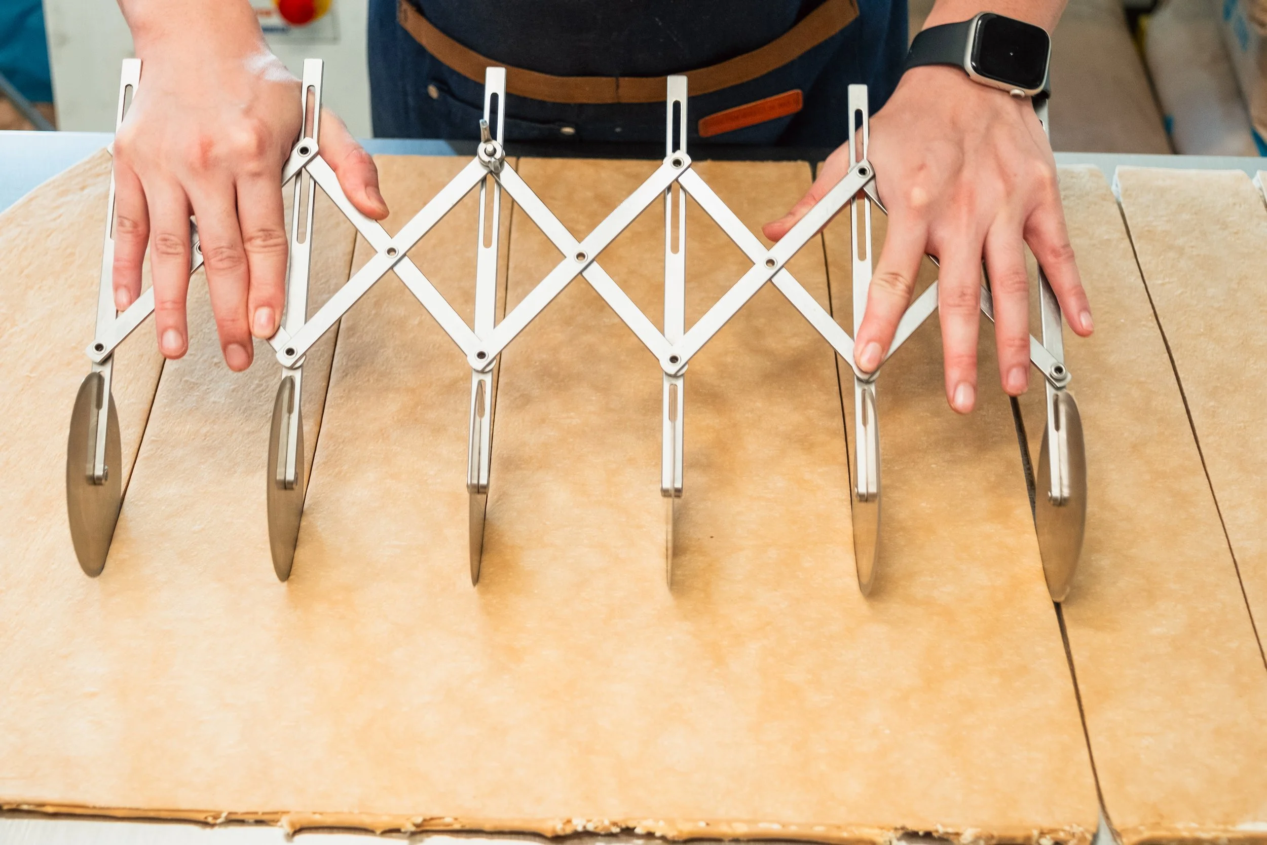 Cutting Dough for Croissants at Butterblock & Co in Calgary, AB. Photograph by Zachery Knudson. All rights reserved.