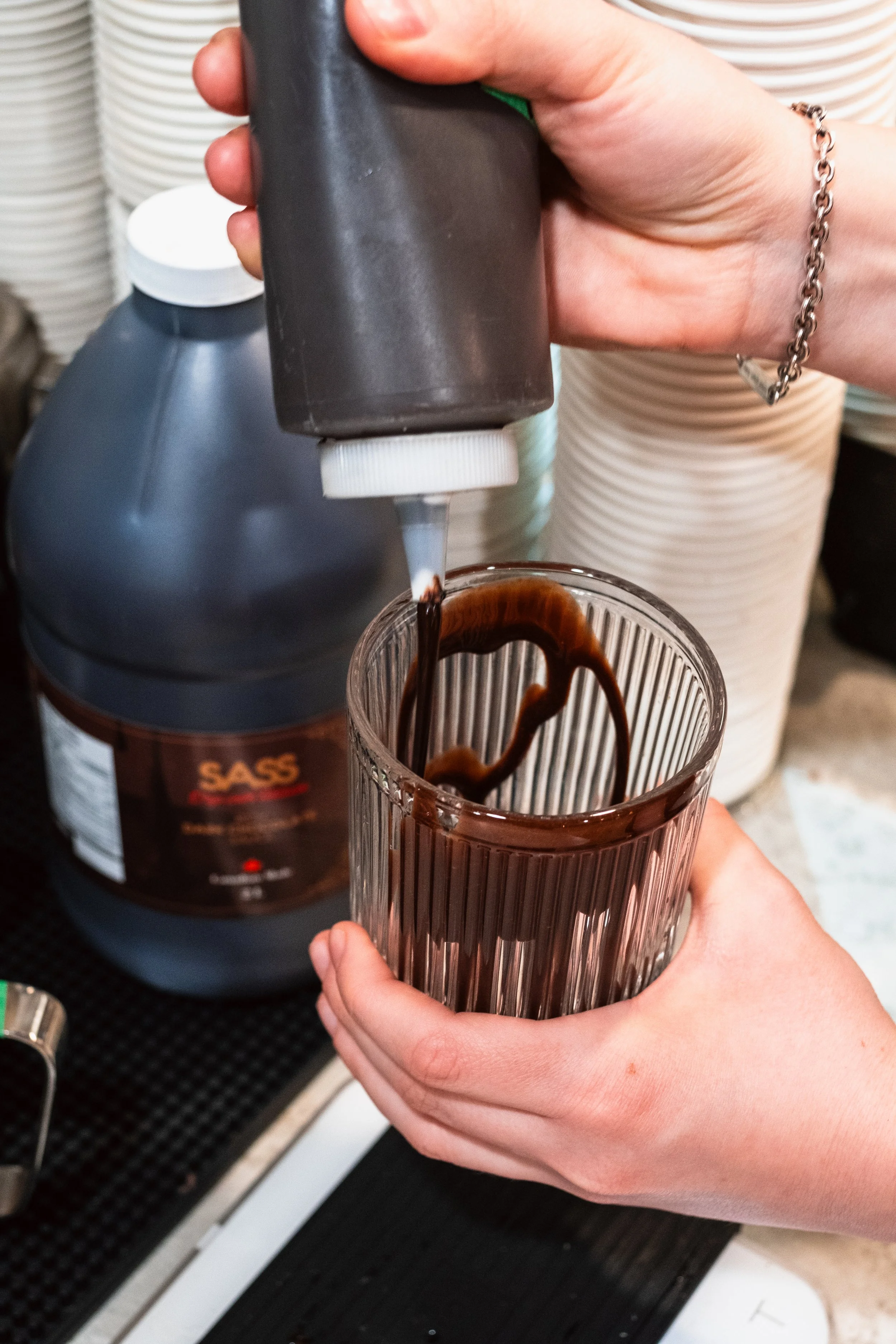 Barista Making Chcolate Drink Using SASS Chocolate Sauce at Butterblock & Co in Calgary, AB. Photograph by Zachery Knudson. All rights reserved.