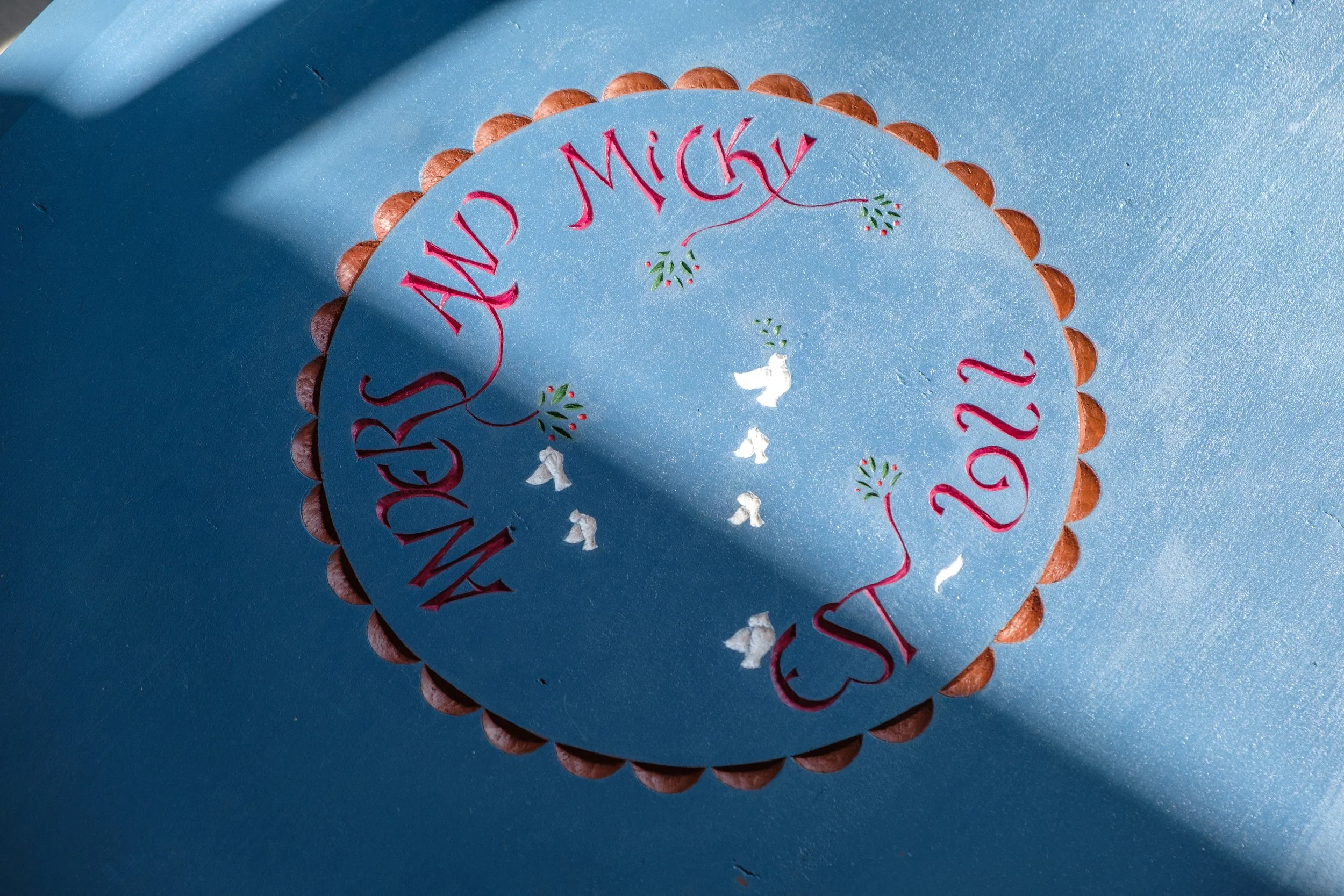 Product Photoshoot for Klein Woodworks. Blue Table with engraving sunlight casts onto the tabletop.