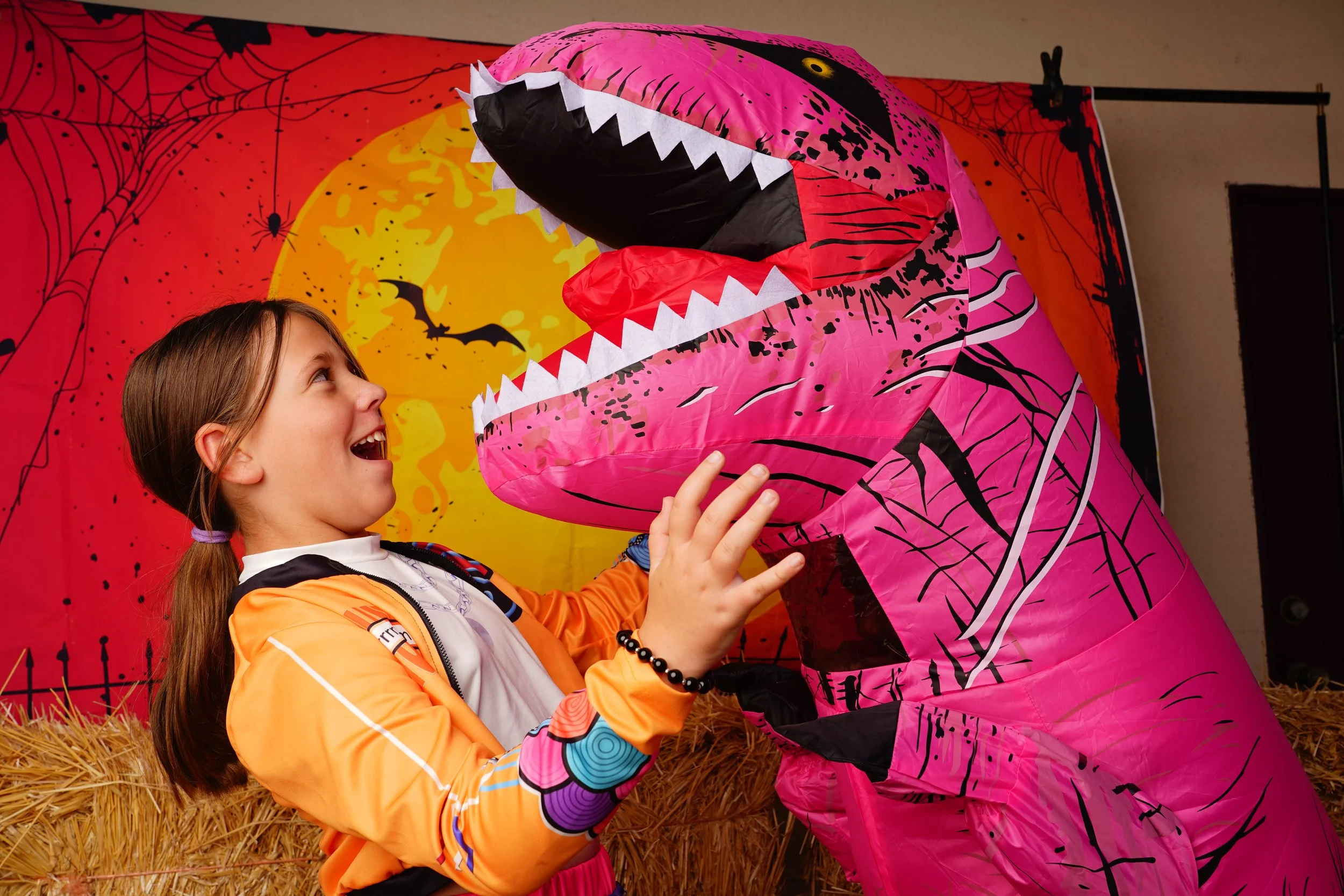 Dinosaur costume threatens a friend