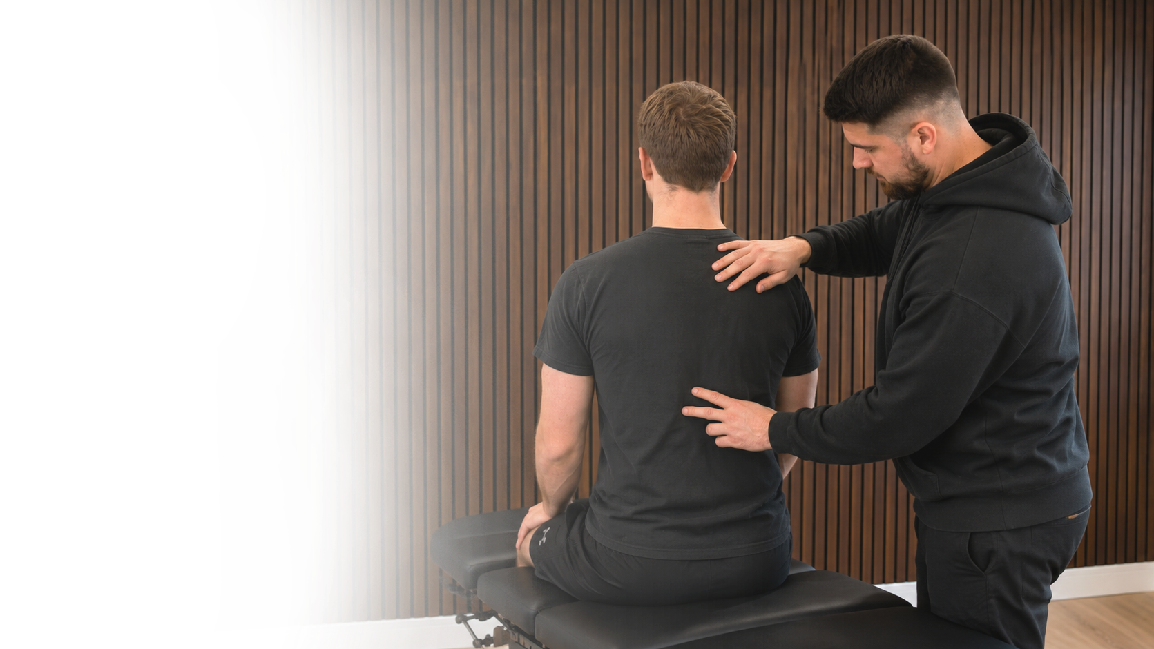 Chiropractor assessing a patient's neck and shoulder at Back In Sync, New Malden