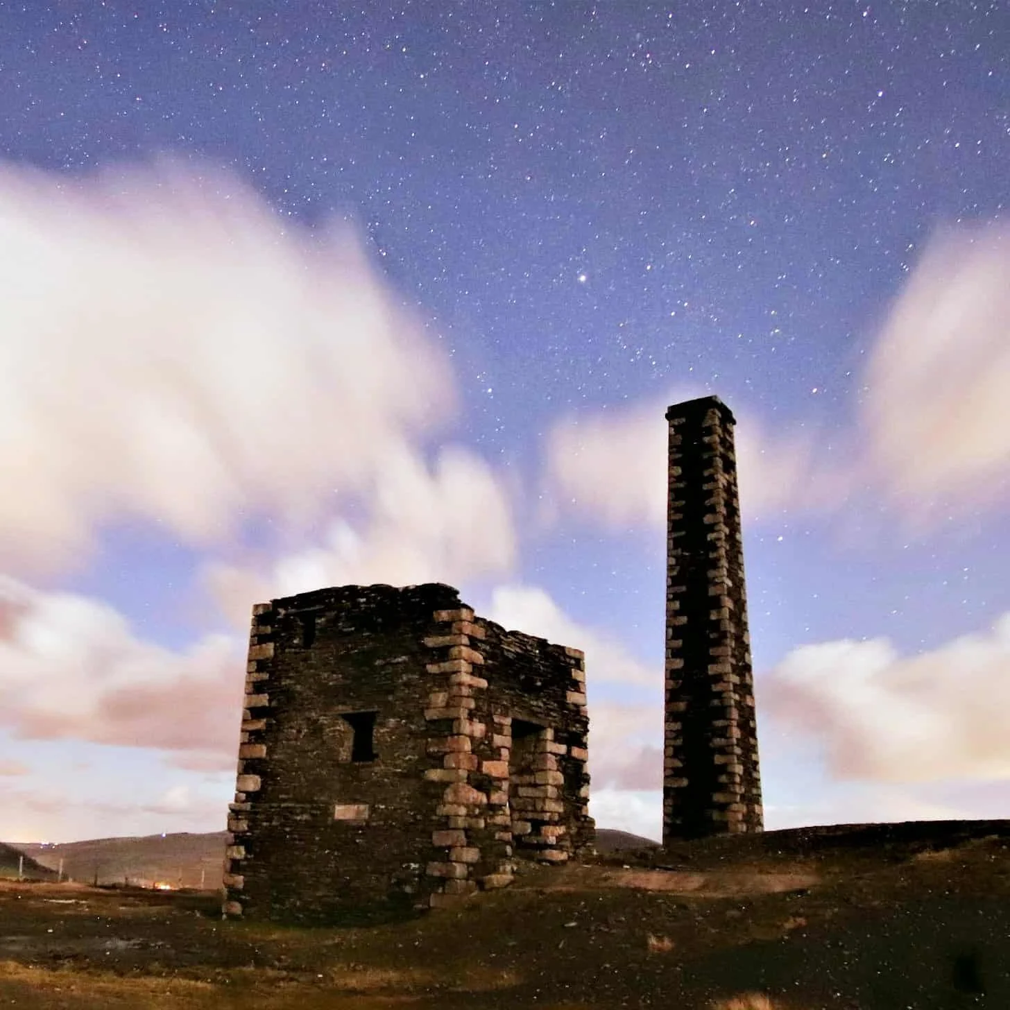 An image of two buildings on the Isle of Man with a starry twilight sky in the background.