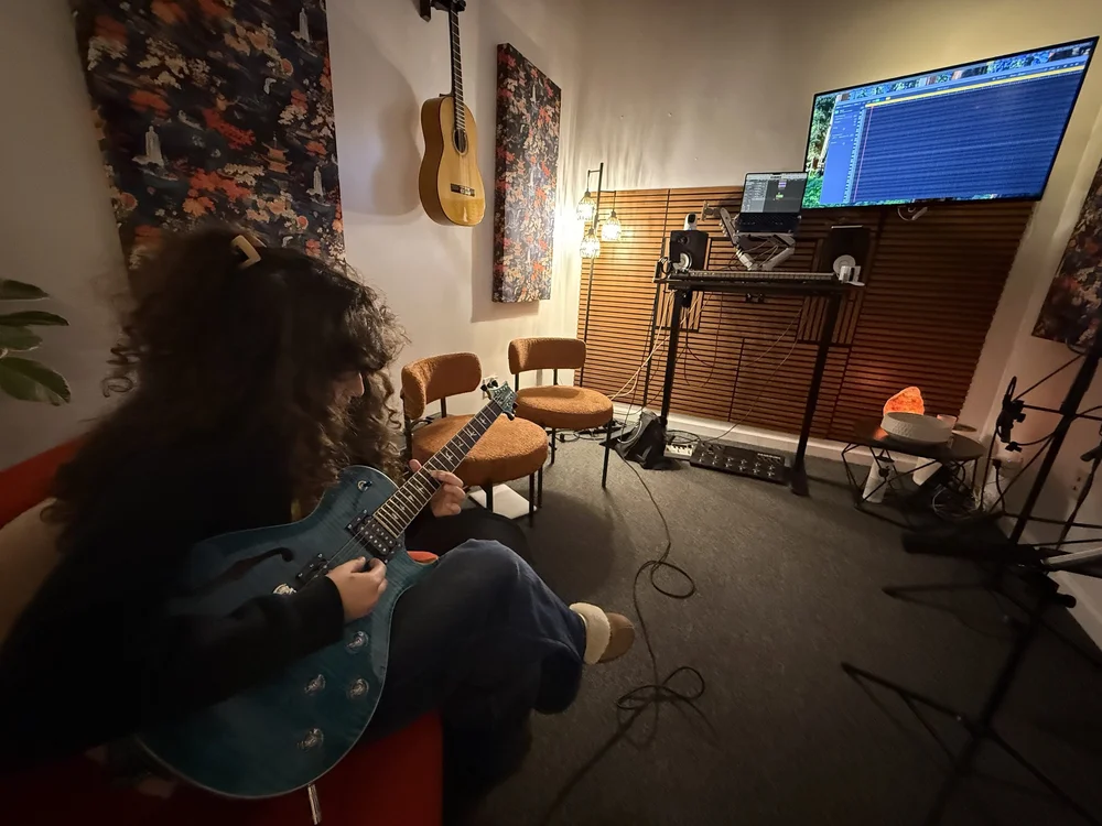 A student playing electric guitar in the Lost Note teaching room