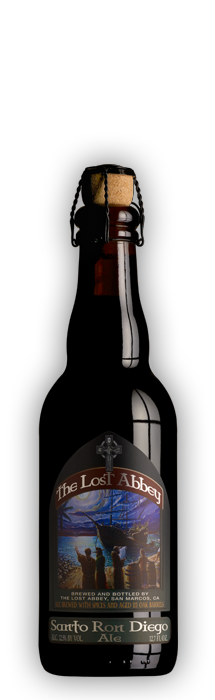 A dark-colored beer bottle with a label that reads 'The Lost Abbey'. The label features an illustration of a boat with a figure rowing, with a blue sky and clouds in the background.