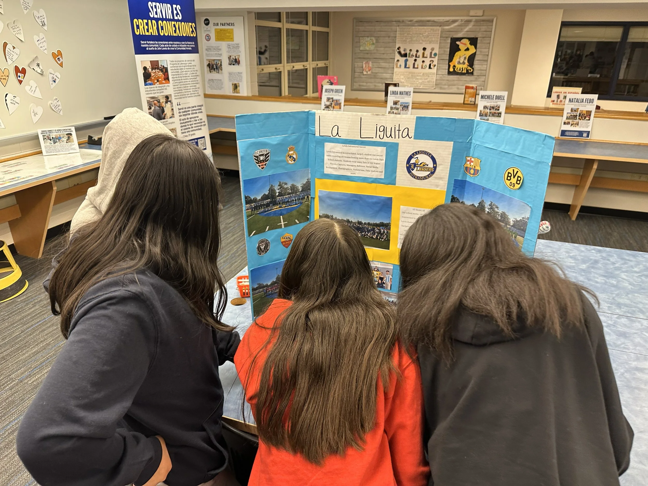 Key Middle School students look at an exhibit about the students who manage an intramural soccer program at Lewis.