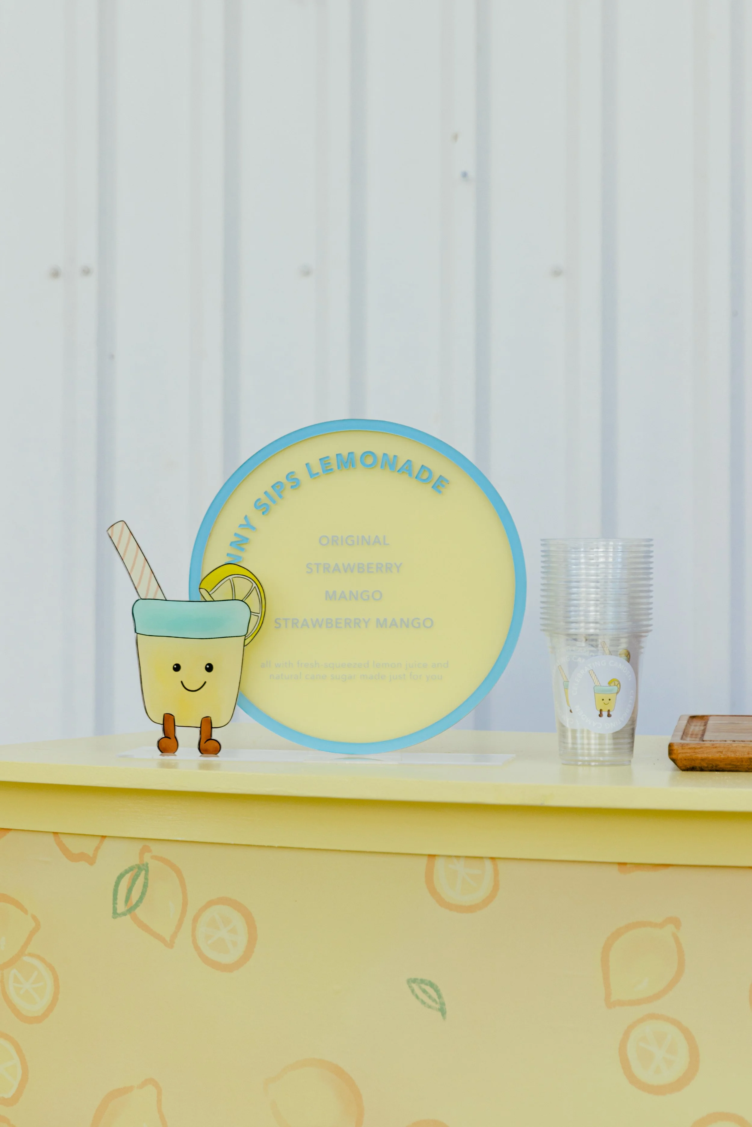 A pastel-colored backdrop, table top sign, table signage, custom signage, custom food menu signage, custom food menu