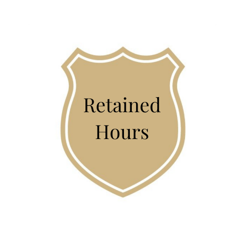 A beige shield-shaped sign with a white border and black text that reads "Retained Hours."