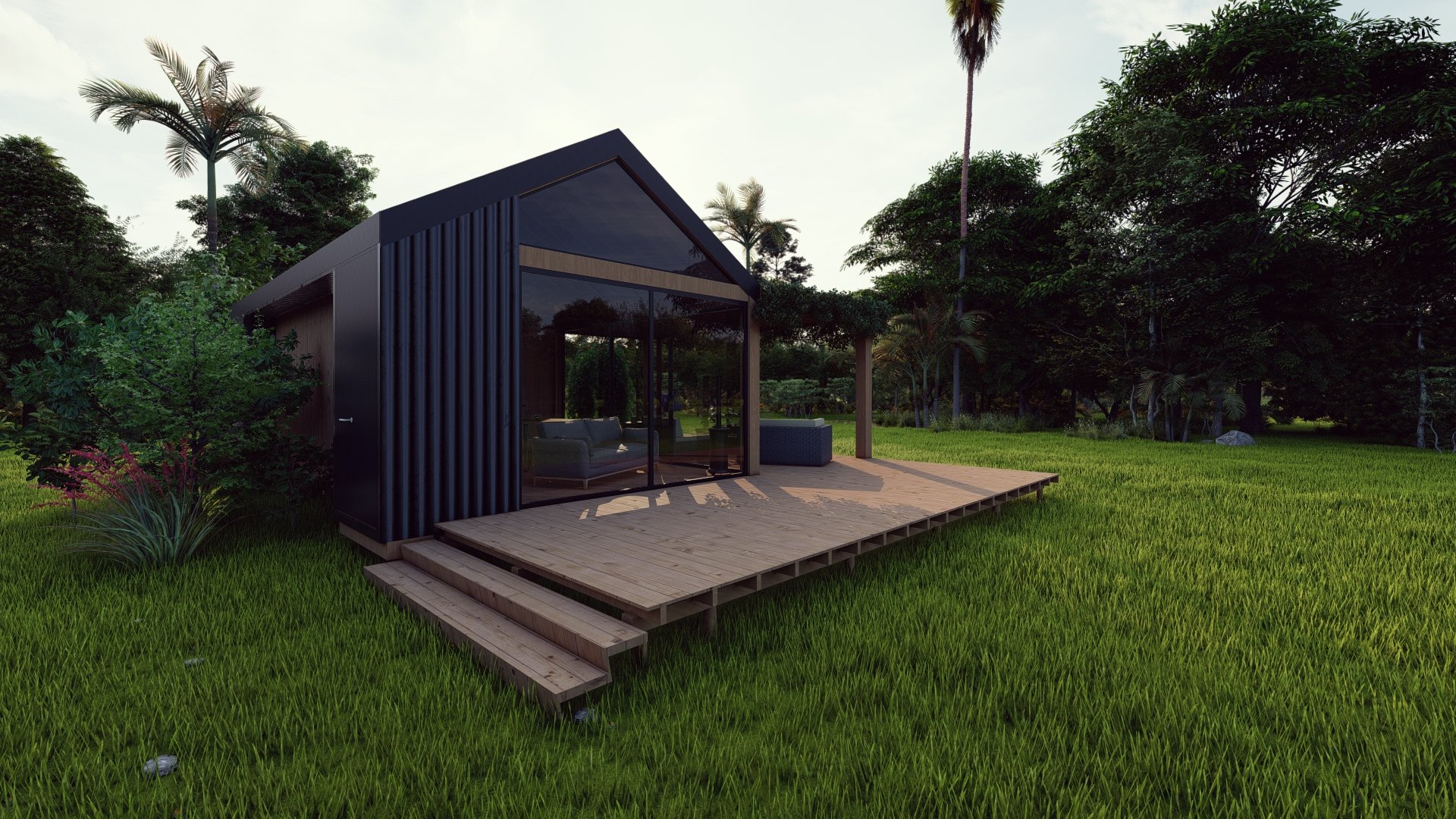Modern small house with a wooden deck in a green outdoor setting, surrounded by trees and grass.