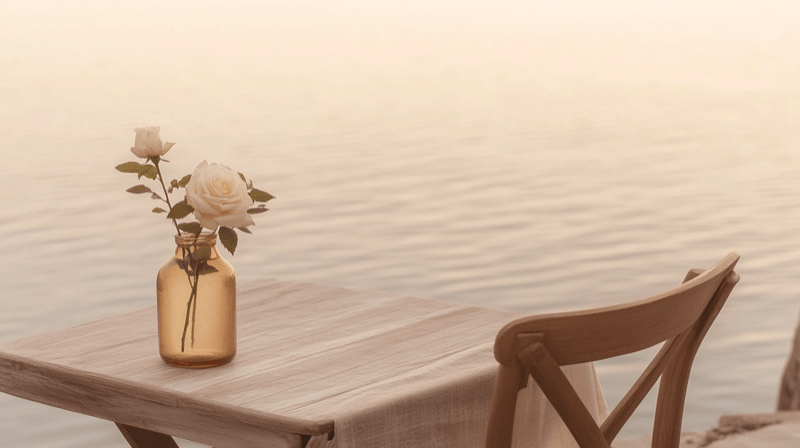 Social isolation as a marriage fraud targeting factor — a single chair at a table set for two overlooking a quiet coastline